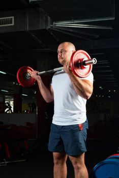 Man in the gym lifts the barbell. bodybuilding and healthy lifestyle