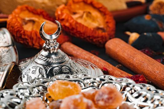 Turkish metal tableware on dark wooden table close up