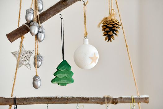 Handmade wooden Christmas tree with toys hanging on the wall