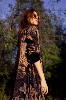 pretty woman wearing sunglasses outdoors fashion nature. High quality photo