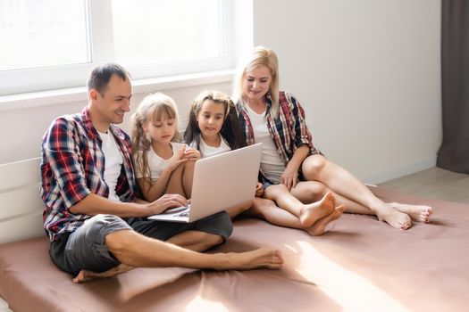 Animated family buying online lying down on bed at home