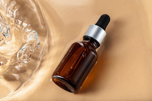Oil cosmetic bottle on water waves background, top view