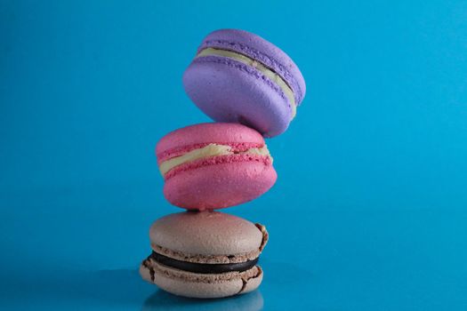 flying flying levitating food macaroon on a blue background with room for text.