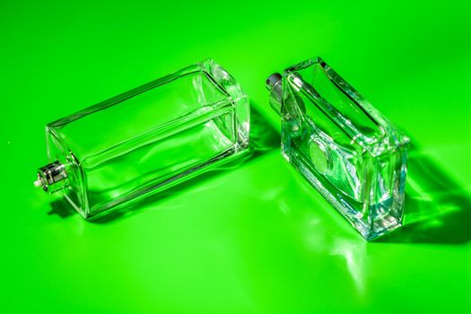 perfume glass bottle on light green background. Eau de toilette