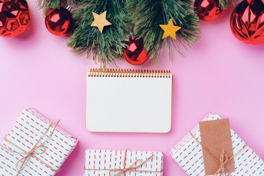 Christmas festive decorations with copy space on pink background, top view