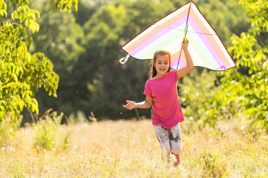Little girl flying a kite