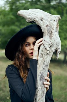 woman in witch costume halloween forest staff gothic. High quality photo