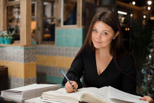 A young girl keeps a record of documents in the workplace