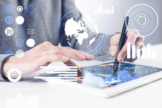 Businessman analyzing financial data. Virtual 3d interface above tablet computer screen. Interactive financial diagrams and digital data visualization. Modern smart technology in business process