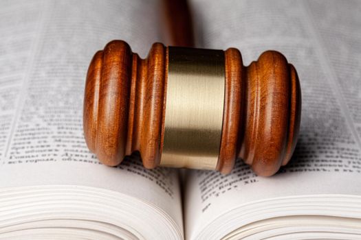 Wooden gavel and juridical books
