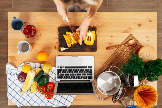 Unrecognizable woman cooking vegetables in her kitchen close up
