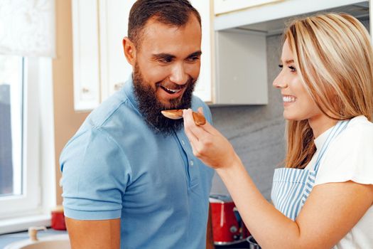 Couple in love preparing meal together in kitchen at home