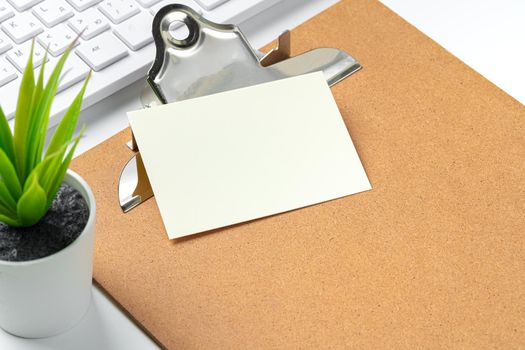 Blank business cards with supplies and keyboard on office table. Close up.