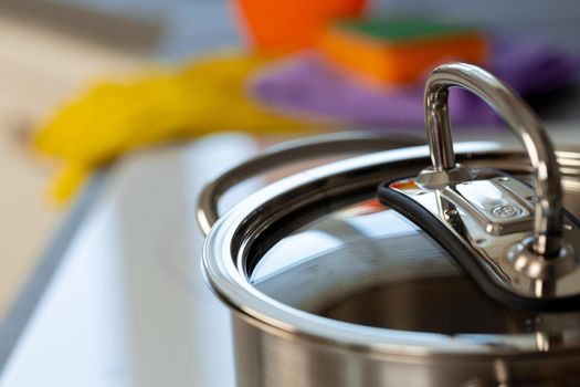 Close up photo of a aluminum cover of a casserole on kitchen counter