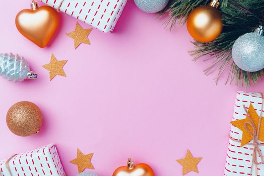 Christmas festive decorations with copy space on pink background, top view