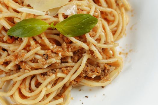 Spaghetti pasta with bolognese sauce and parmesan cheese, top view.