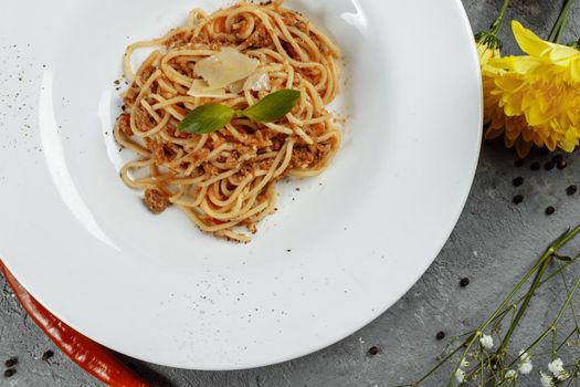 Spaghetti pasta with bolognese sauce and parmesan cheese, top view.