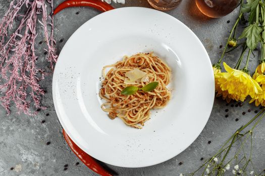 Spaghetti pasta with bolognese sauce and parmesan cheese, top view.