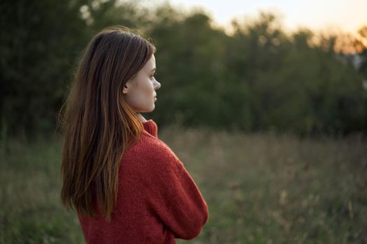 woman outdoors in a field walk fresh air. High quality photo