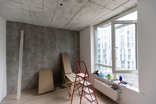 Home renovation in room full of painting tools