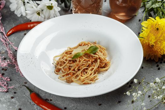 Spaghetti pasta with bolognese sauce and parmesan cheese, top view.