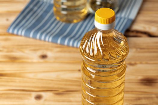 Olive oil bottle on wooden table.