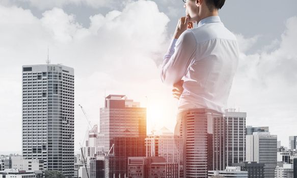 Double exposure of elegant businessman with hand on chin looking away