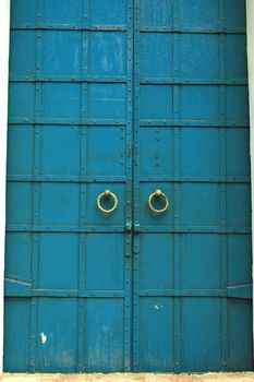 Old vintage large blue wooden church door.