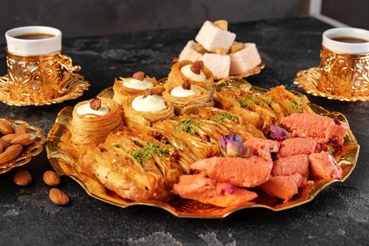 Turkish dessert baklava with a cup of coffee on black background, close up