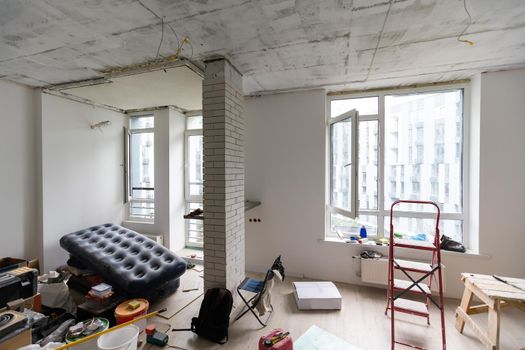 Interior of apartment with materials during on the renovation and construction, remodel wall from gypsum plasterboard or drywall