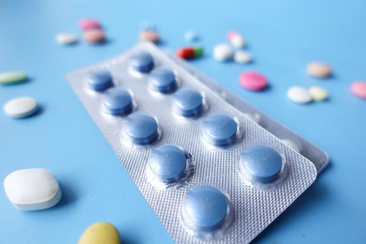 Close up of pills of blister pack on table .