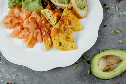 omelet with red fish and vegetables, beautiful serving.