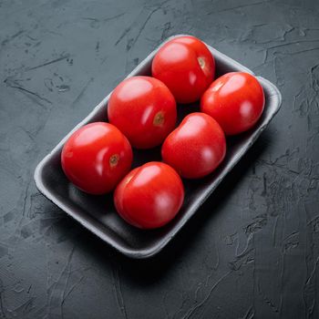 Red tomatoes, on black background