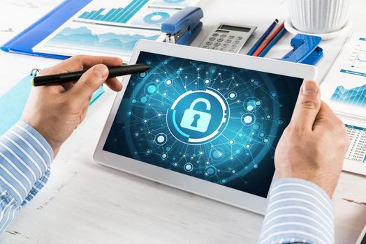close-up, male hands with tablet. Businessman working at the table in office. computer security concept