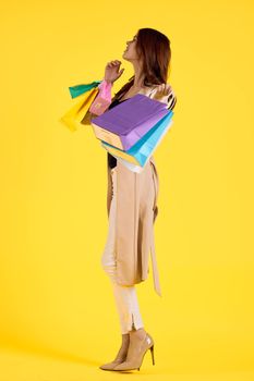 cheerful woman with packages in hands Shopaholic studio model. High quality photo