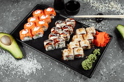 Sushi set with fresh ingredients on gray background. Sushi menu. Japanese food.