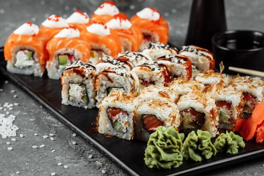 Sushi set with fresh ingredients on gray background. Sushi menu. Japanese food.