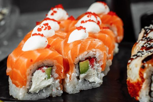 Sushi set with fresh ingredients on gray background. Sushi menu. Japanese food.