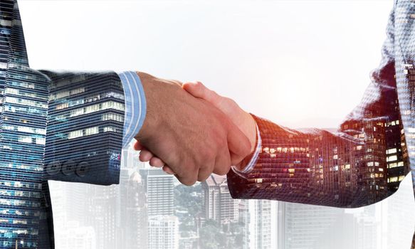 Close-up of the handshake of businessmen. Against the backdrop of the cityscape