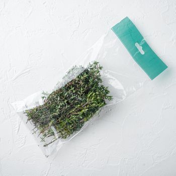 Thyme in plastic bag set, on white background, top view flat lay