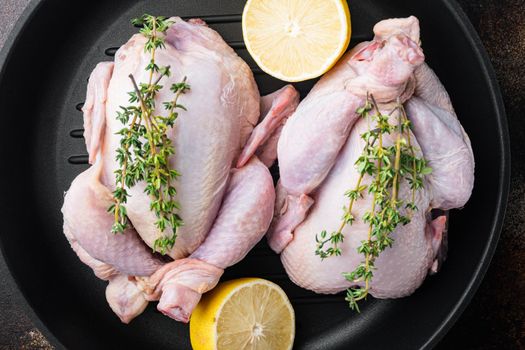 Raw organic uncooked whole chicken meat on grill pan, on old rustic background, top view