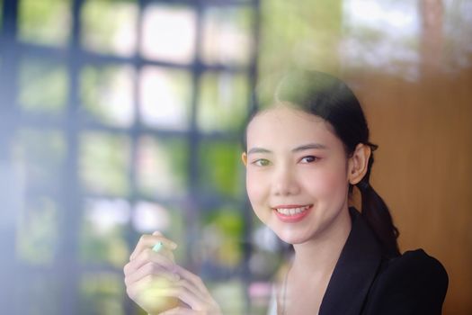 A woman with a happy smile on her face through a mirror