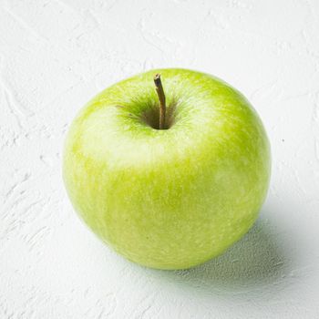 Granny smith apple set, on white stone table background, square format