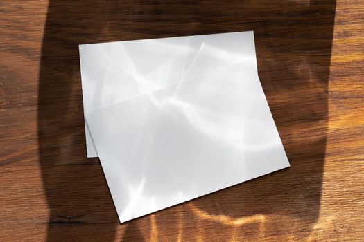 Blank white business cards on wooden background. Close up.