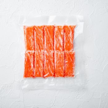 Crab fish meat sticks in vacuum pack set, on white background, top view flat lay