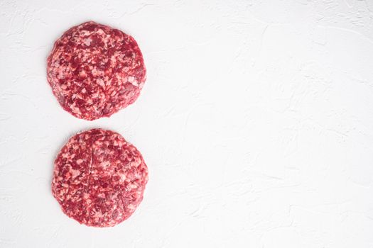 Patty of minced meat for burger set, on white stone background, top view flat lay, with copy space for text