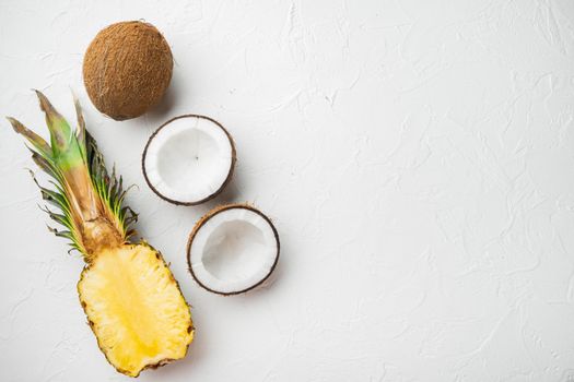 Creative layout made of Exotic and tropical fruits, pineapple and Coconut set, on white stone table background, top view flat lay, with copy space for text