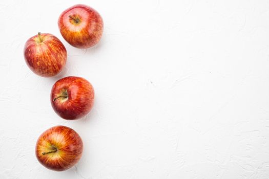 Ripe red apples set, on white stone table background, top view flat lay, with copy space for text