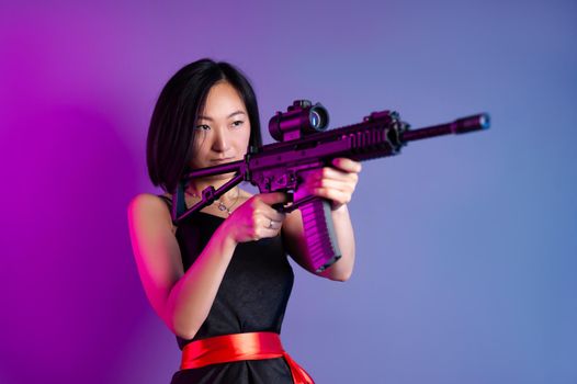 the asian woman with a machine gun aims for shooting