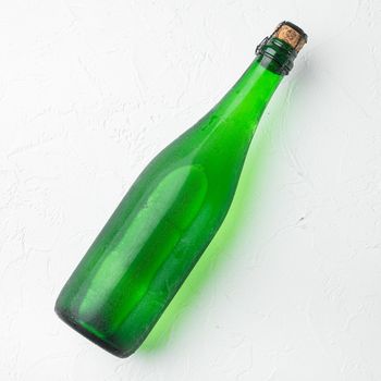 Glass bottle sparkling set, on white stone table background, top view flat lay, square format